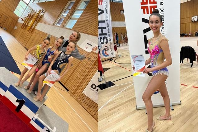 Vier junge Tänzerinnen stehen auf dem Treppchen mit Urkunden, eine weitere zeigt stolz ihre Auszeichnung an einer Tafel.