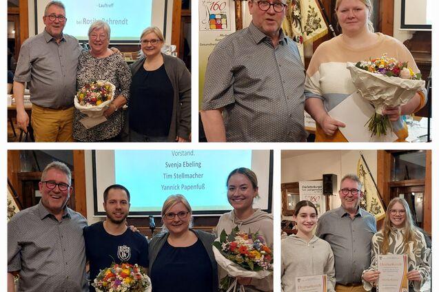 Gruppenfoto von Teilnehmern einer Jahreshauptversammlung mit Blumensträußen und Urkunden in einem festlichen Raum.